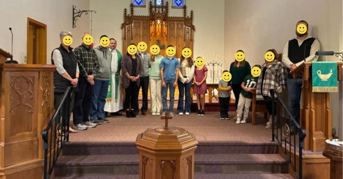 group of people standing at the front of a church